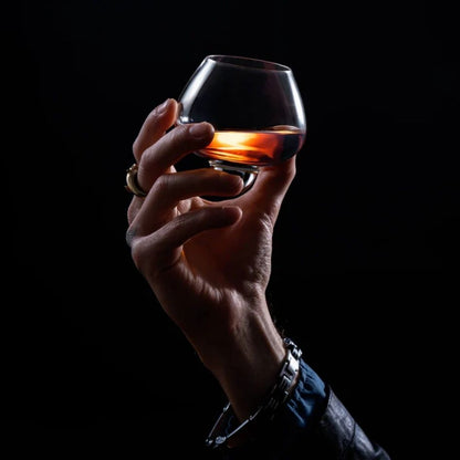 EQUILO No.1 spirits glass held in hand with bourbon